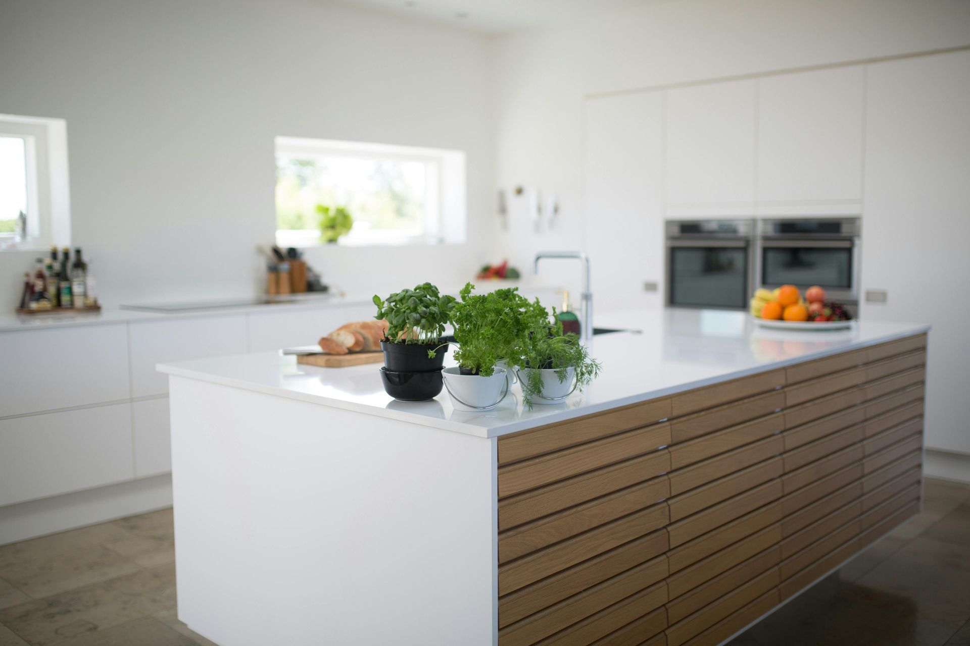 Modern white kitchen with wood island and quartz countertop