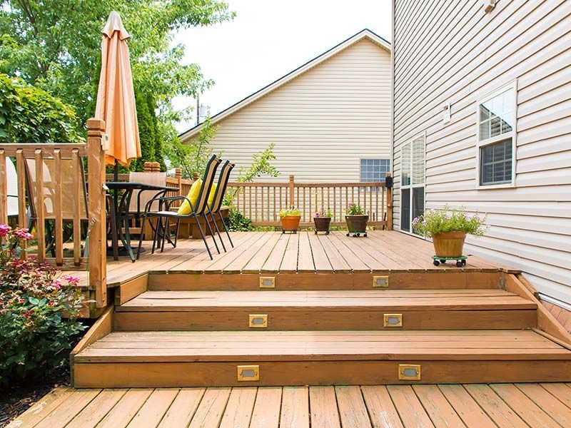 Backyard wood deck with built-in steps and seating area