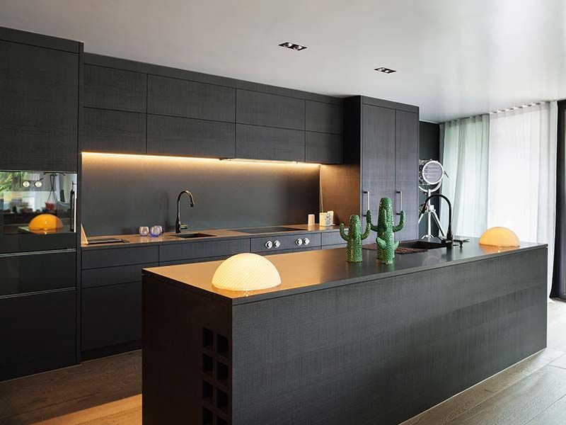 Modern dark kitchen remodel with waterfall island