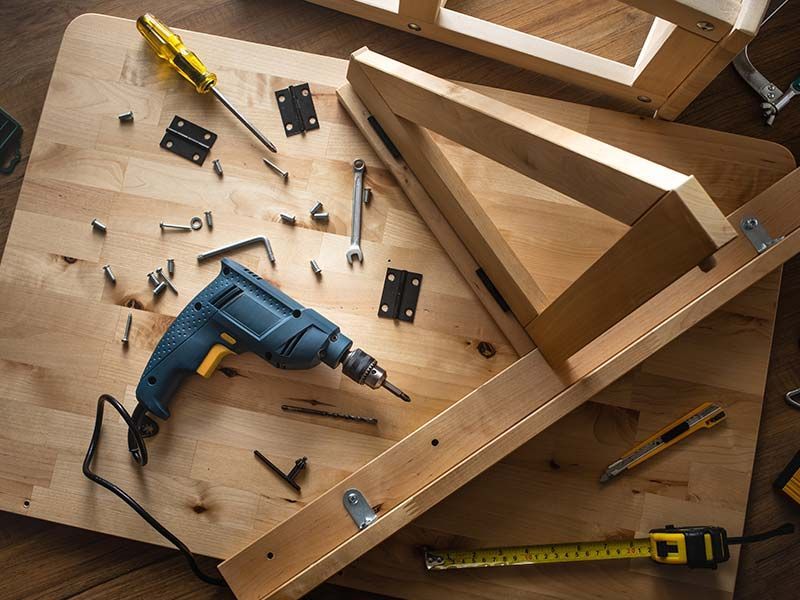 Carpenter assembling custom wood furniture