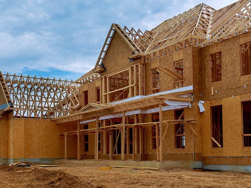 New home under construction with wood framing and roof trusses