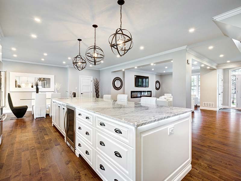 Open-concept white kitchen remodel with large island